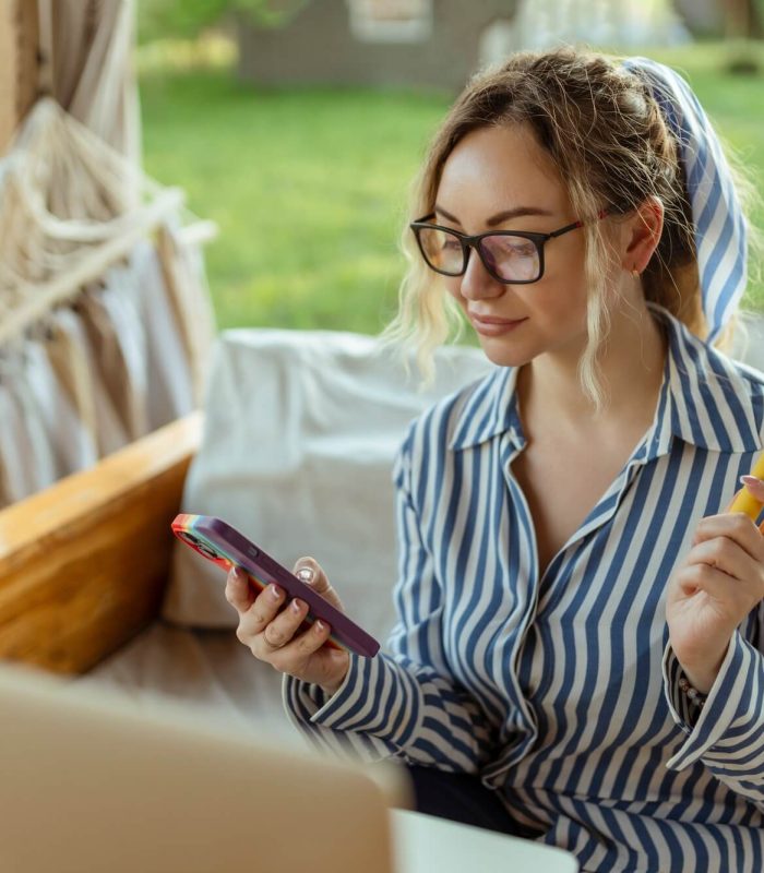 a-beautiful-girl-smokes-an-electrode-cigarette-and-uses-a-smartphone-event-organizer.jpg